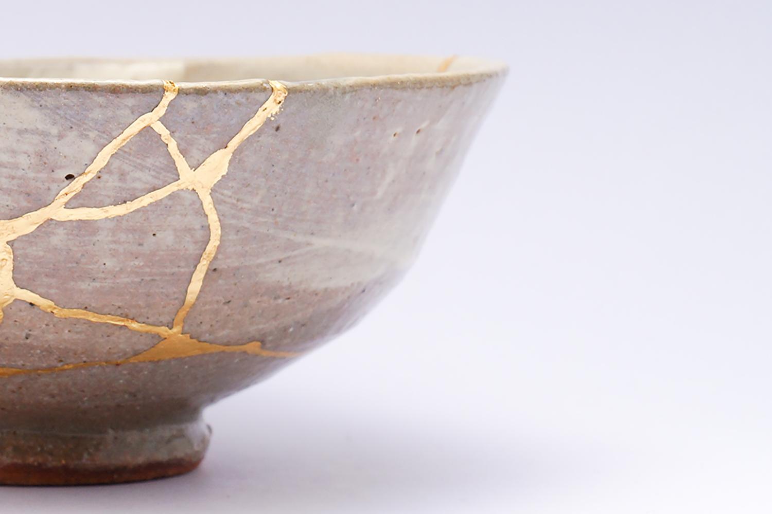 A Japanese bowl mended with gold in the kintsugi tradition — a picture of restoration